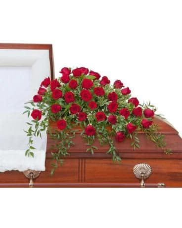 Three dozen Roses with premium foliage in a casket spray.