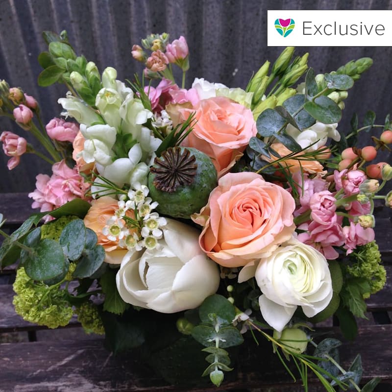 A beautiful and lush centerpiece for an elegant table. Featuring roses, tulips