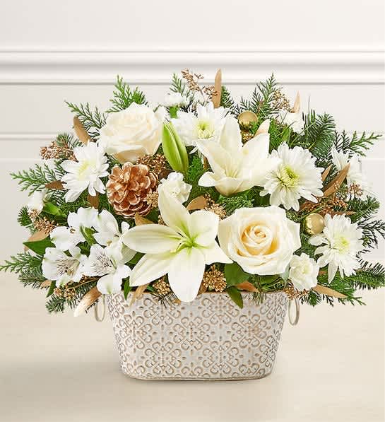 Round arrangement with cream roses, white lilies, alstroemeria, mini carnations. Accented with