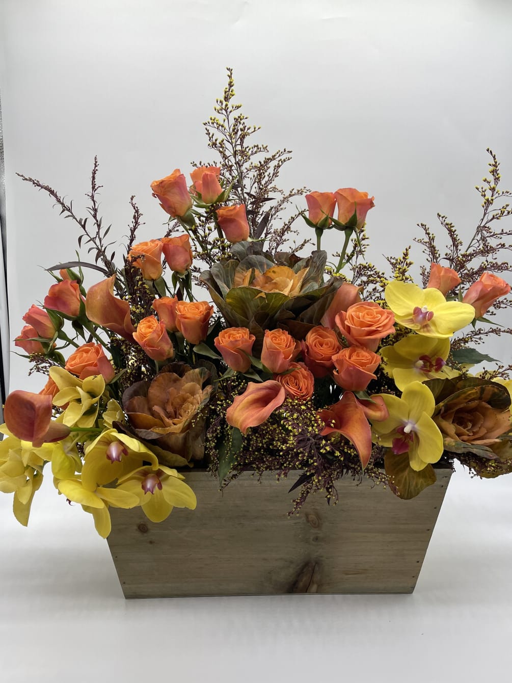 A Beautiful combination of orange roses mixed with calla lilies and bright