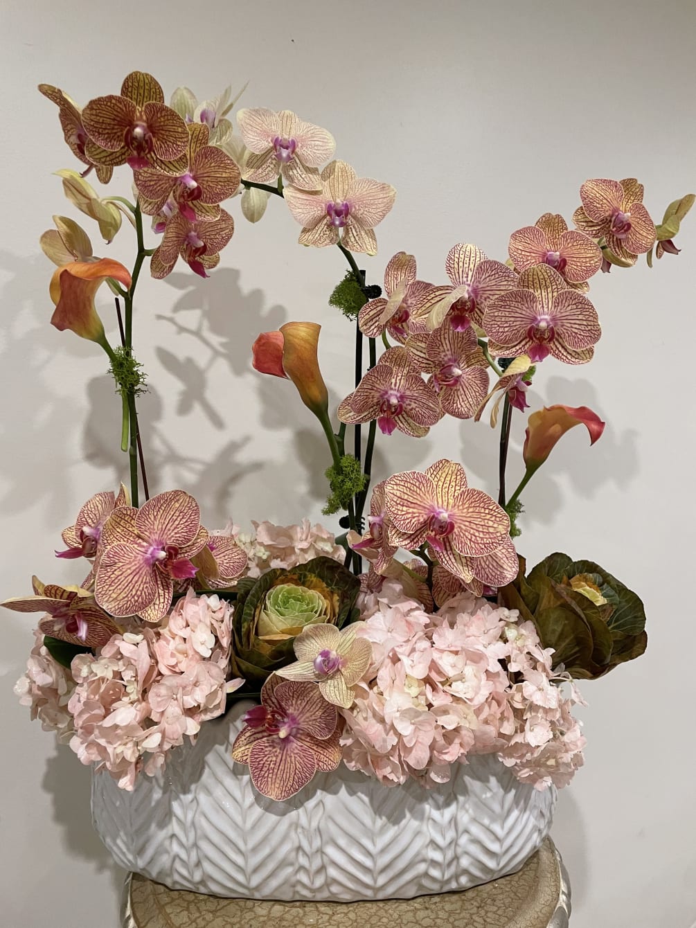 Beautifully designed orchids, peach orchids, mini calla lilies &amp; Ornamental cabbage 