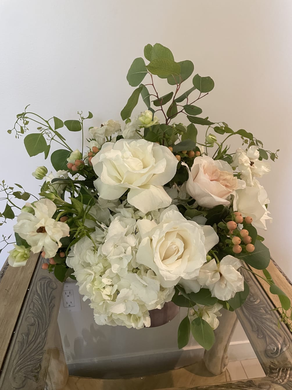 Soft pastel roses, white roses, white hydrangea and ranunculus accented by eucalyptus