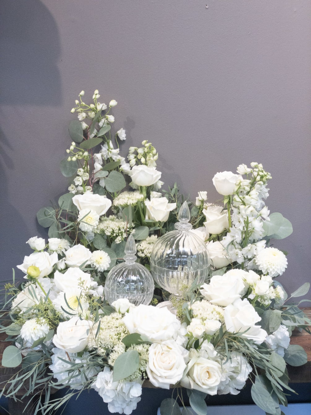 This arrangement is a flat-lying wreath with a space in the center