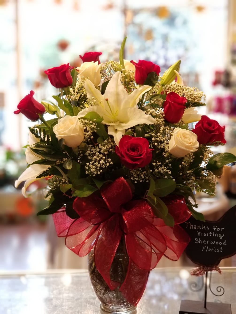 Romantic Red and White Roses Set Between Lavish Lilies and Garden Greenery