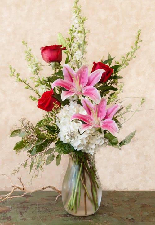 Spring 77
Stargazer lilies with white hydrangeas and red roses and other filler