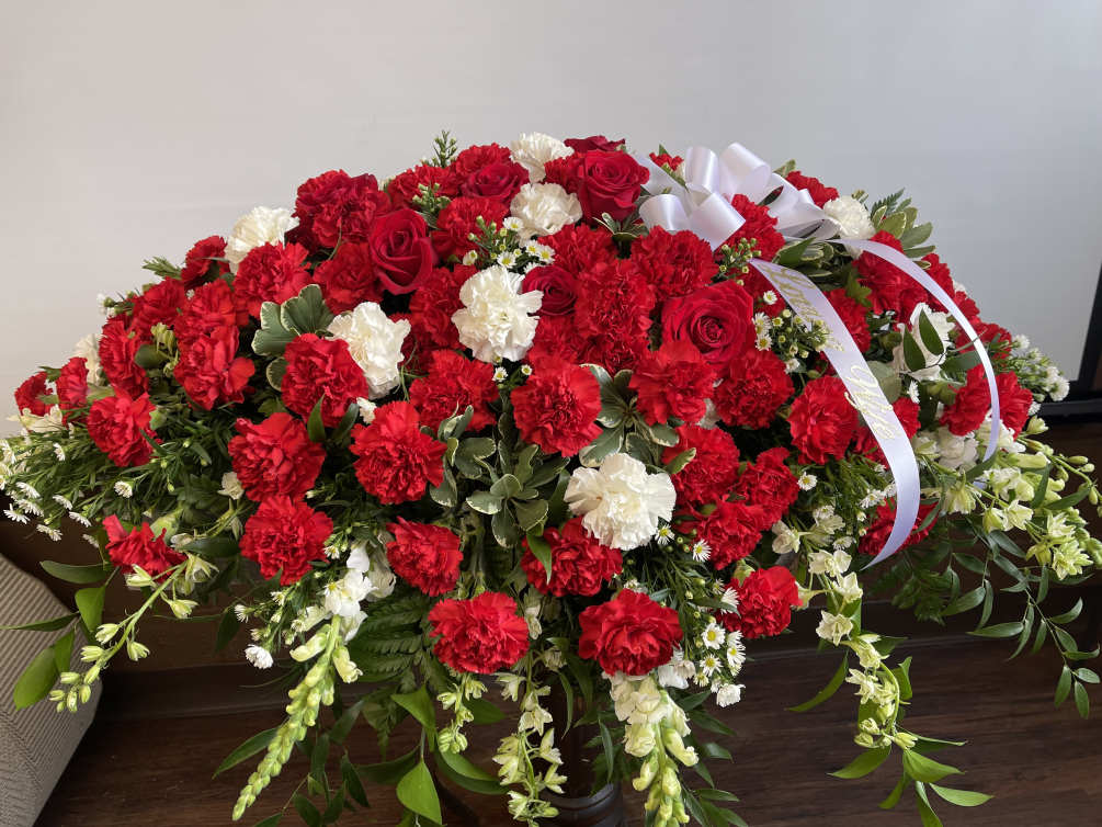 Traditional red and white casket spray