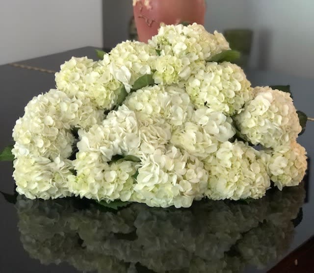 15 stems of white hydrangea wrapped in floral paper.