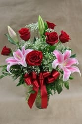 A classic combination of six red roses and pink stargazer lilies arranged