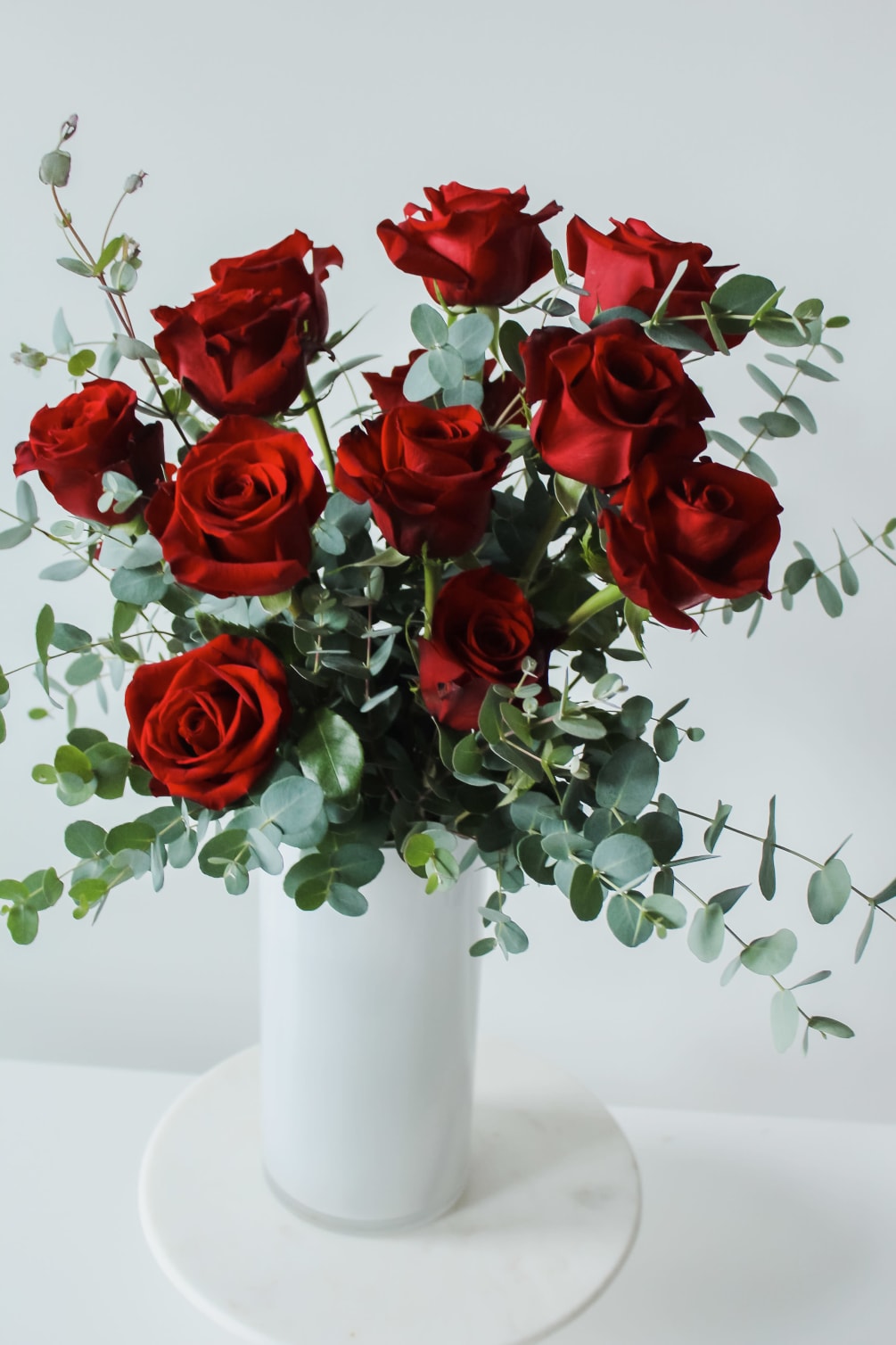 Send you love with our classic dozen long stem red roses floating