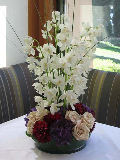 Unique arrangements with Pave of Gorgeous mixed seasonal flowers on the base