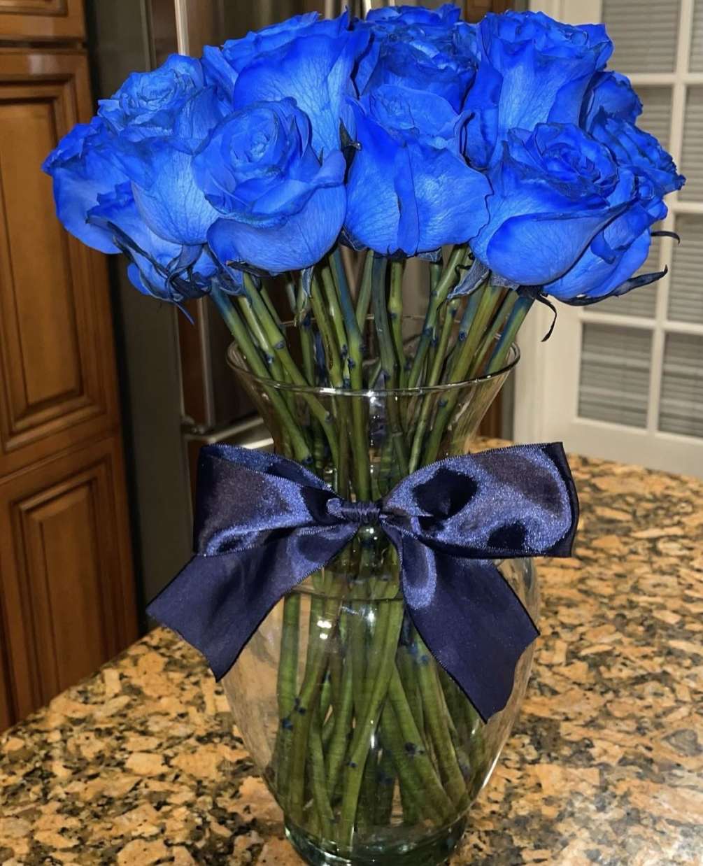 A dozen of Blue Roses  arranged in a beautiful clear glass