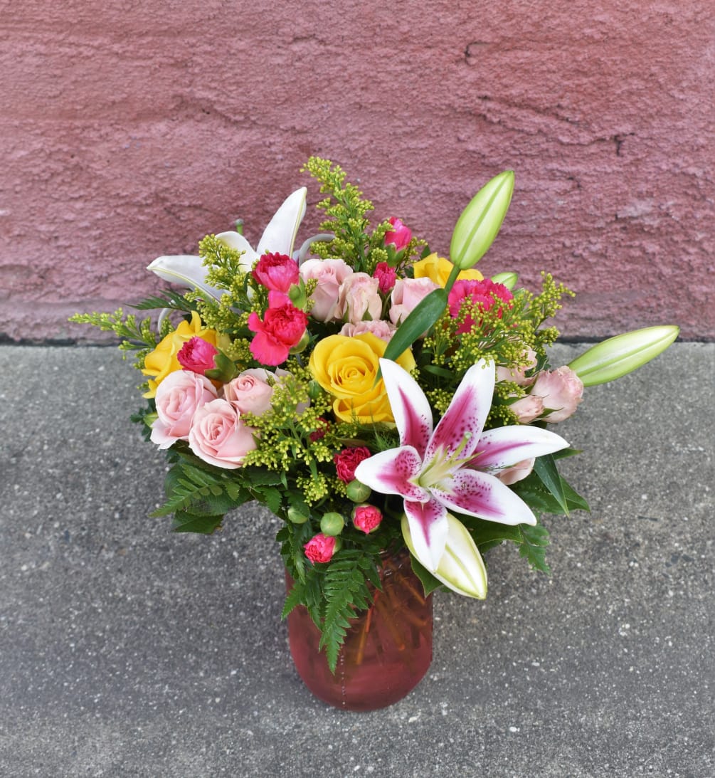  Bright stargazers, yellow roses, pink spray roses and miniature carnations are