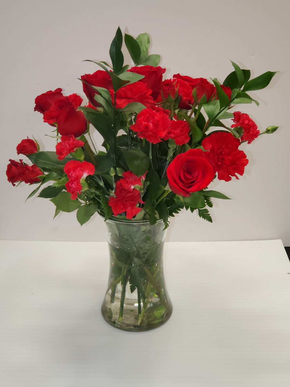 All red arrangement in a clear vase 