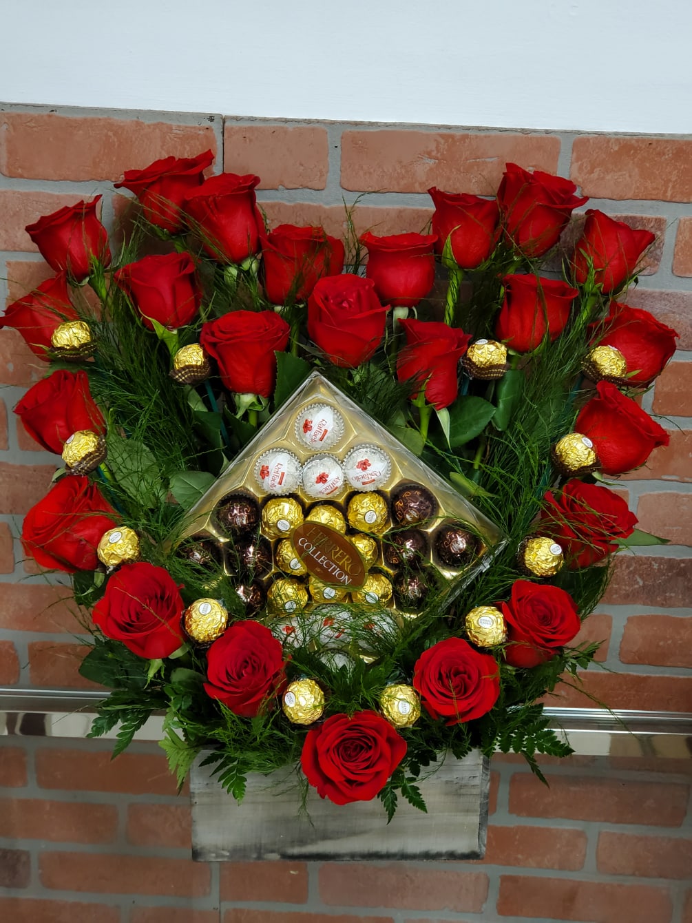 24 Red roses with a box of chocolate in a wood box.
