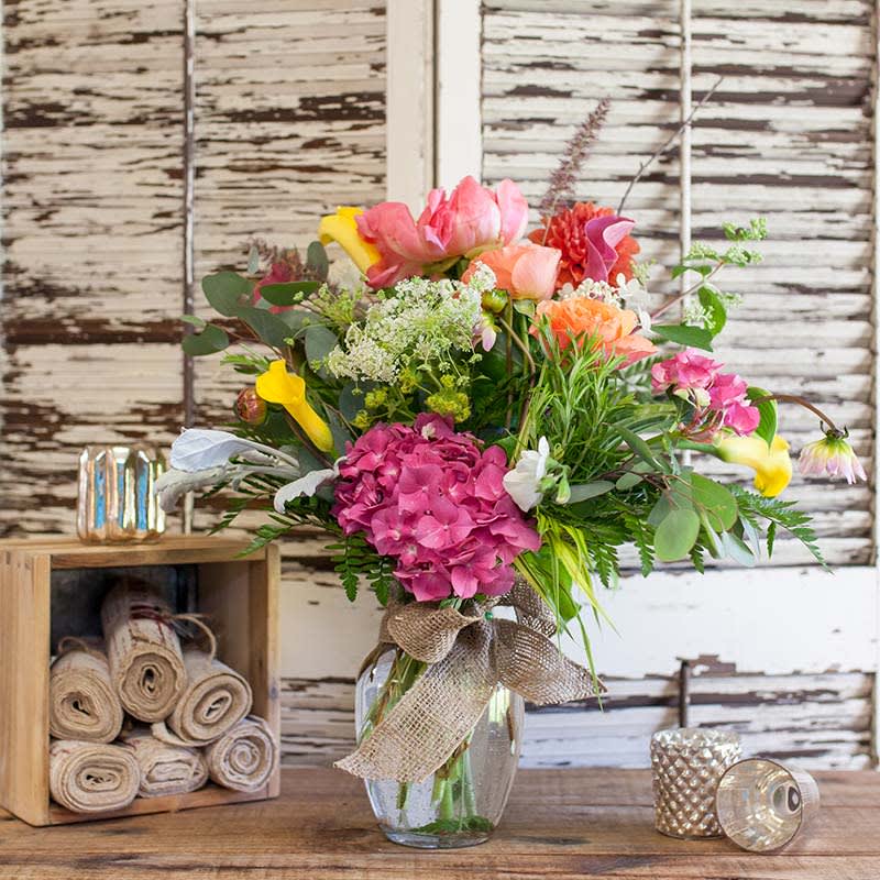 Large vase with an assortment of seasonal flowers.  Sure to make