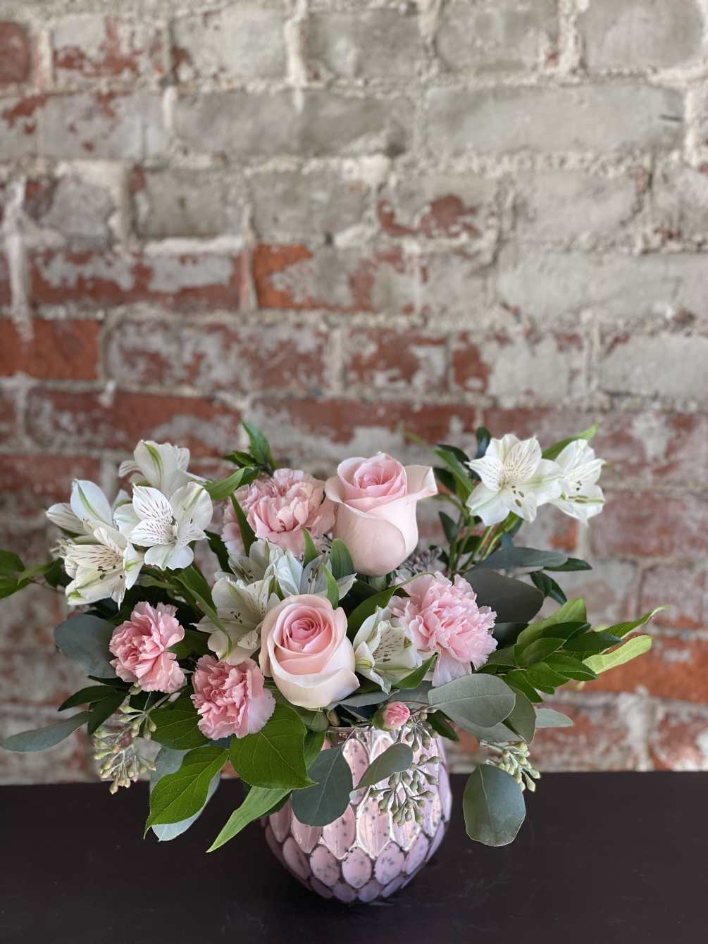 Soft and sweet, this pastel pink rose bouquet gets the glam treatment