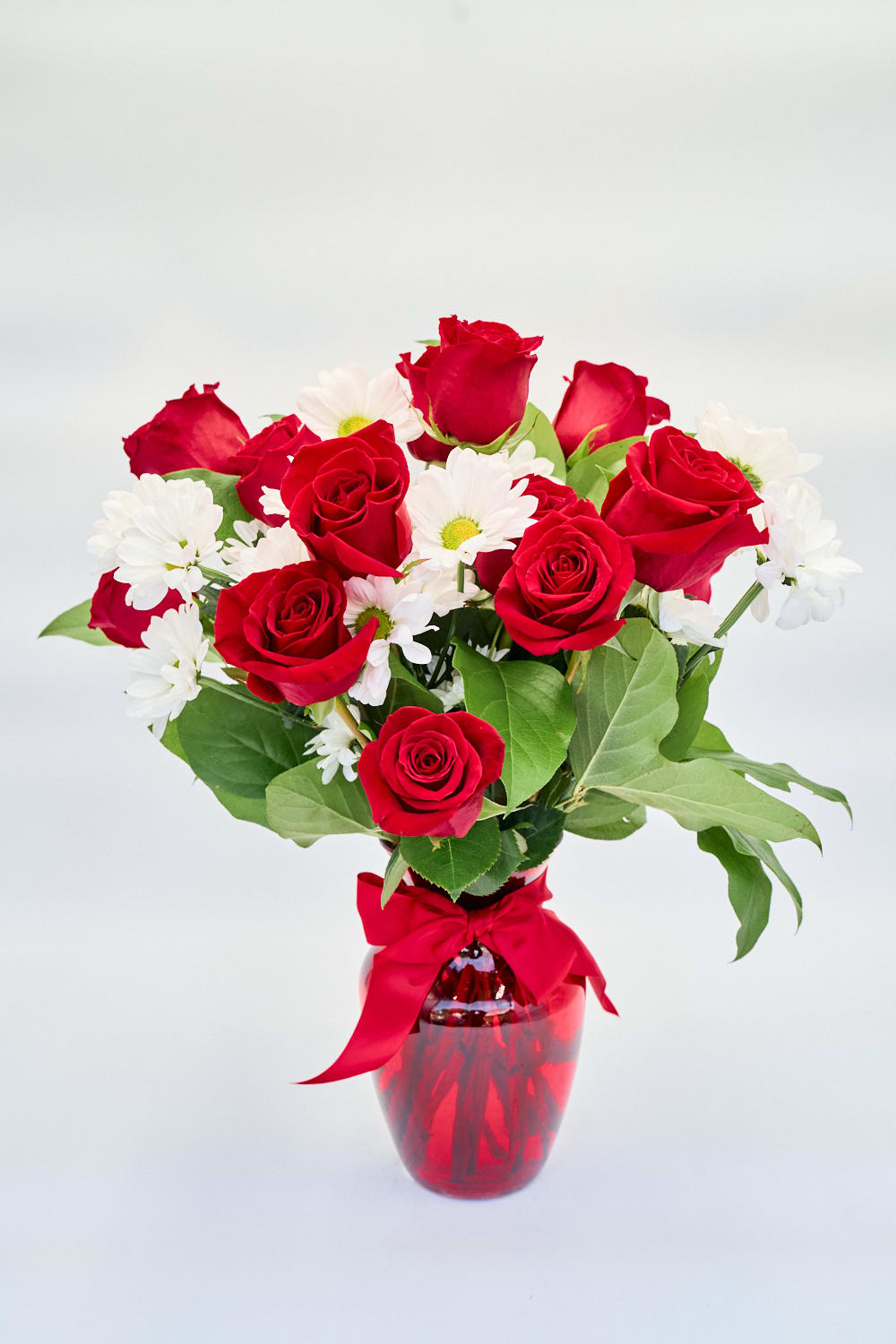 Roses and Daisies in a red glass vase, finished with a red