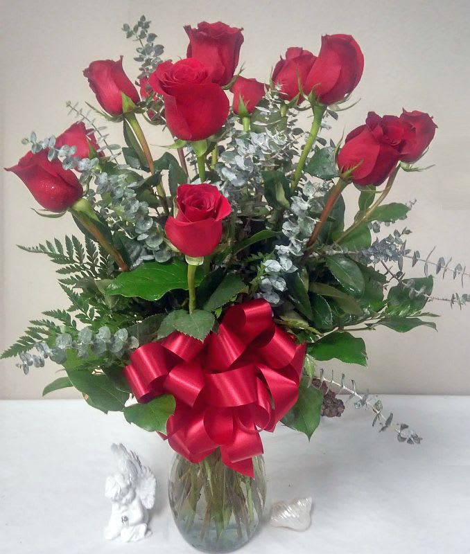 One Dozen Roses arranged with Eucalyptus in a vase with a bow