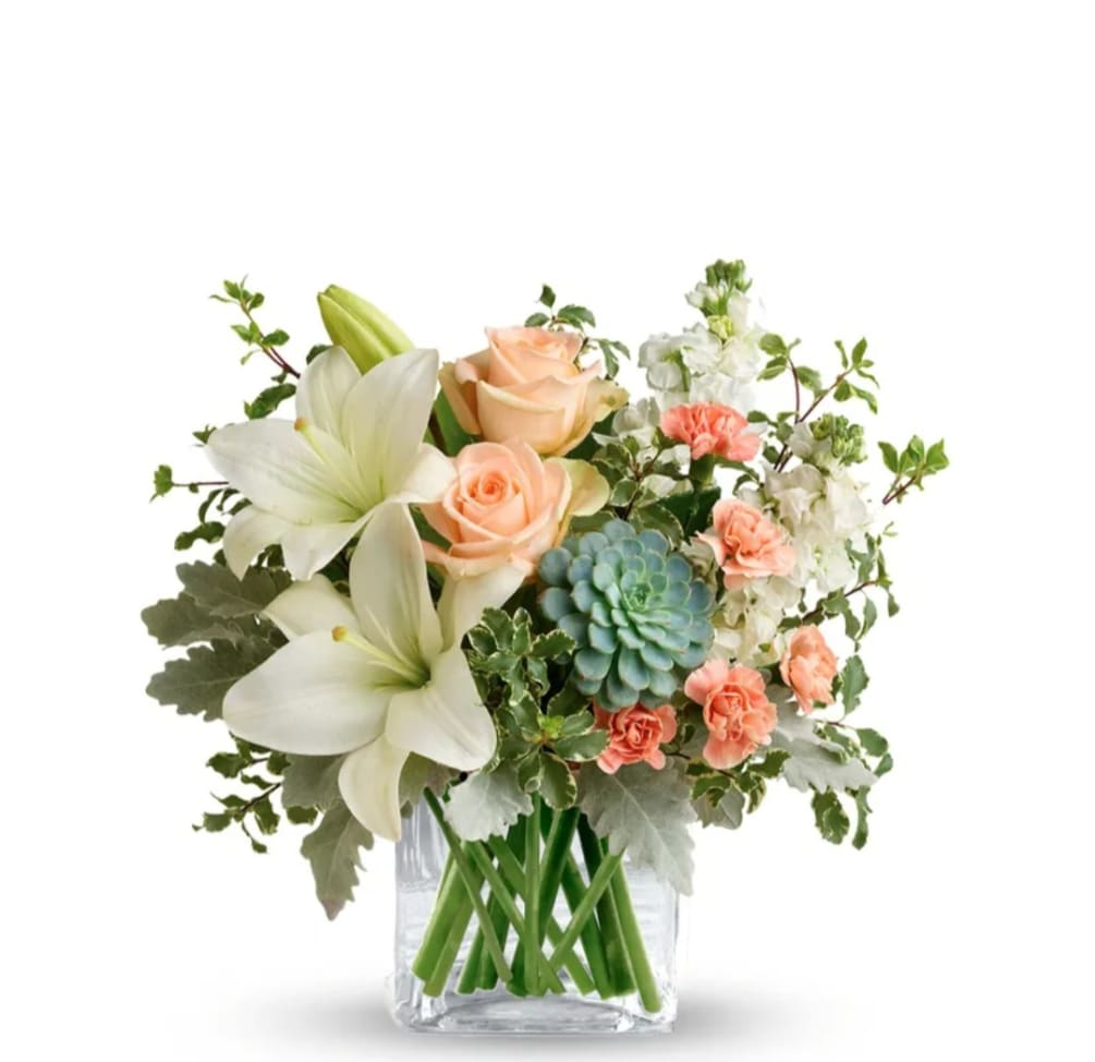 A beautiful mix of white and peach in season blooms designed in