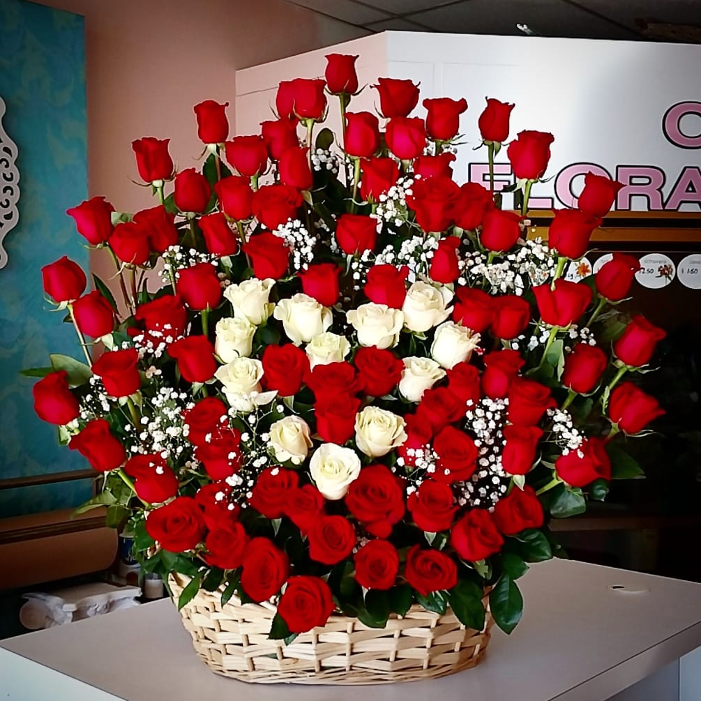 This large basket has 90 stems of roses with a dozen white