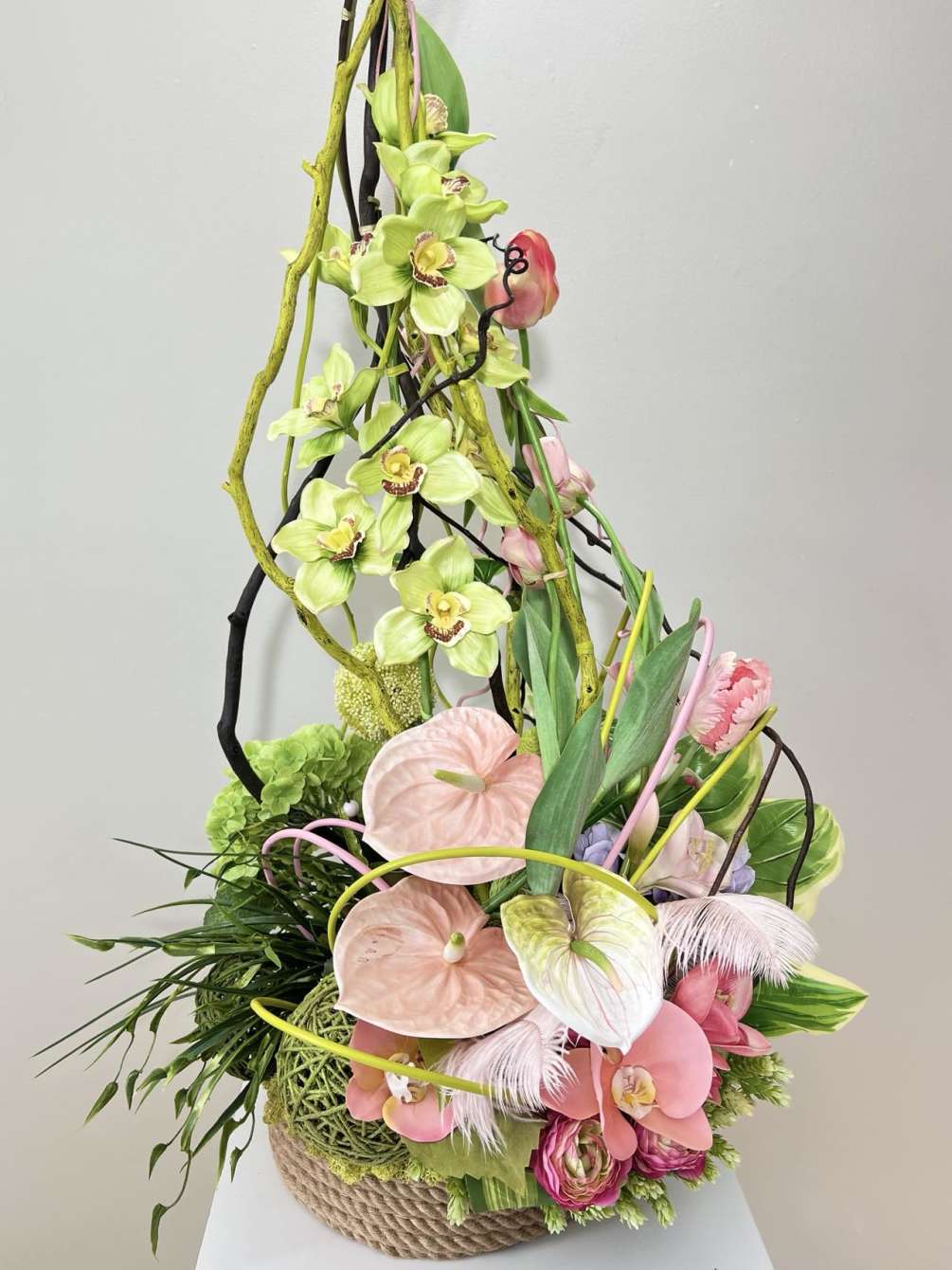 The delicate light pink hues of the tropical silk flowers evoke a