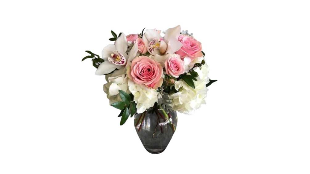 A delightful assortment of roses, carnations, orchids, and hydrangea in pastel springtime