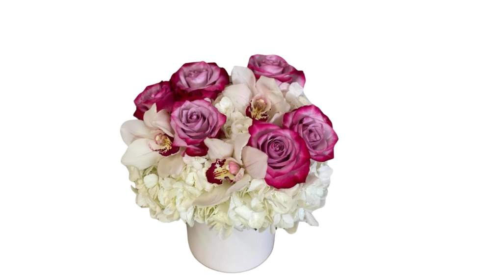A mix of hydrangea, orchids and roses in a beautiful container. Container