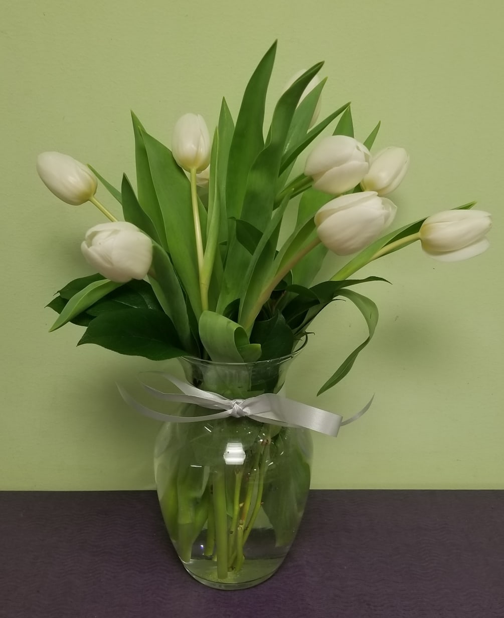 10 beautiful white Tulips arranged in a glass vase!