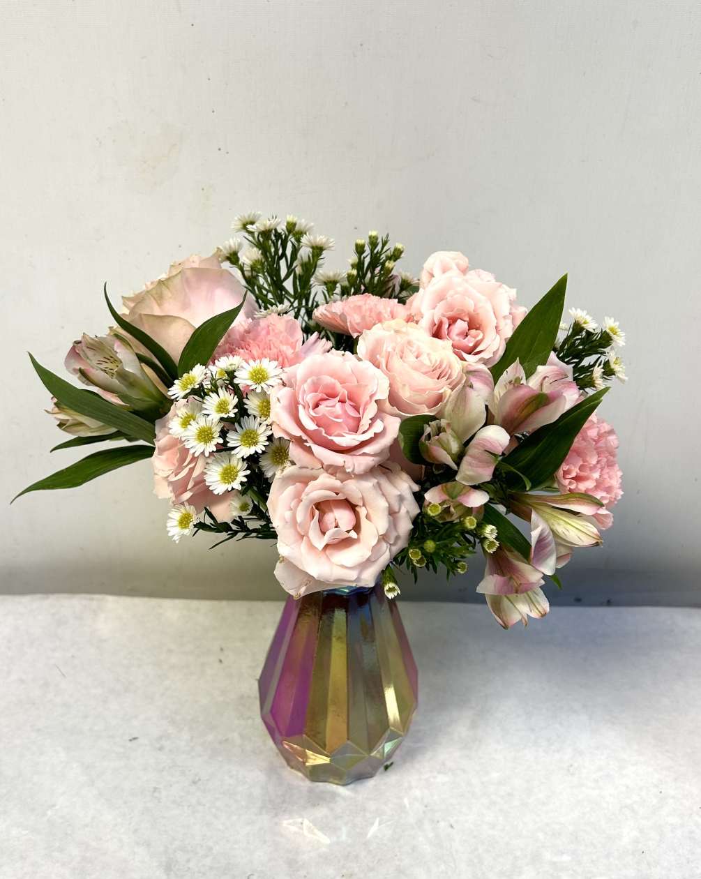 Feminine and dainty all pinks in an irredescent pink vase. The perfect