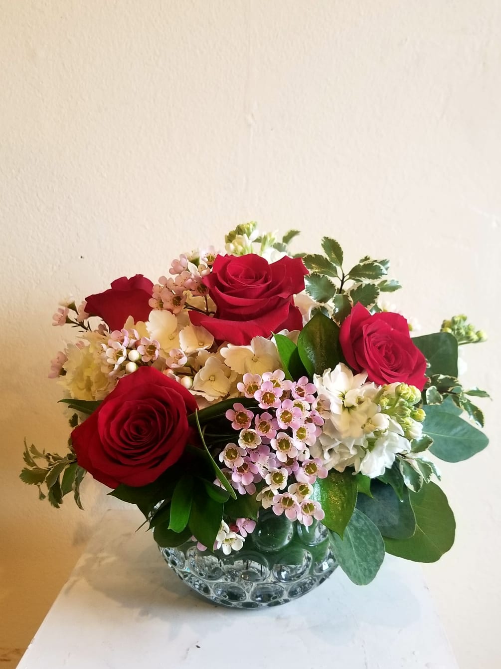 Roses, hydrangea, and accent flowers.
