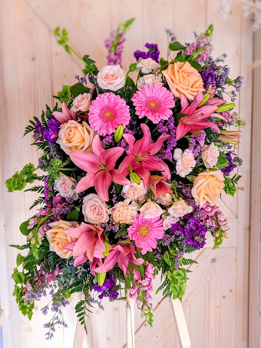 Pastel color variety flowers on a standing easel. 