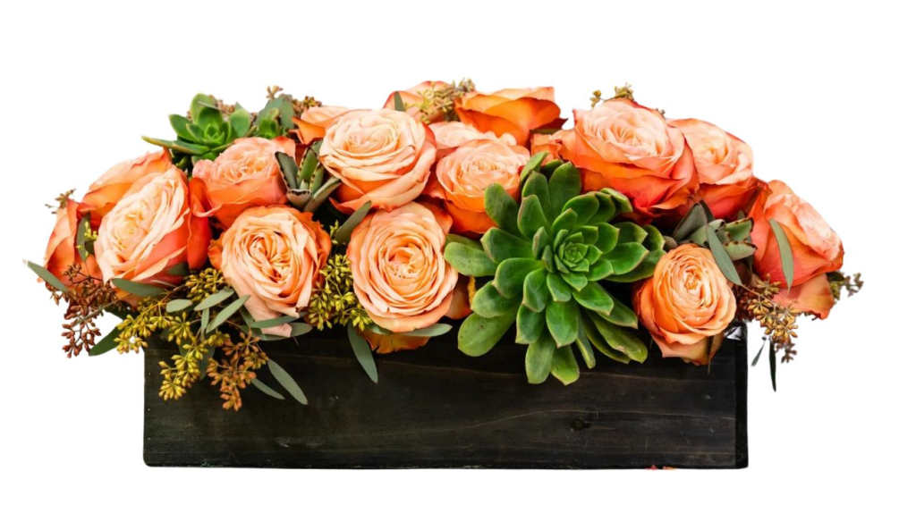 Fresh cut flowers and succulents arranged in a wooden box