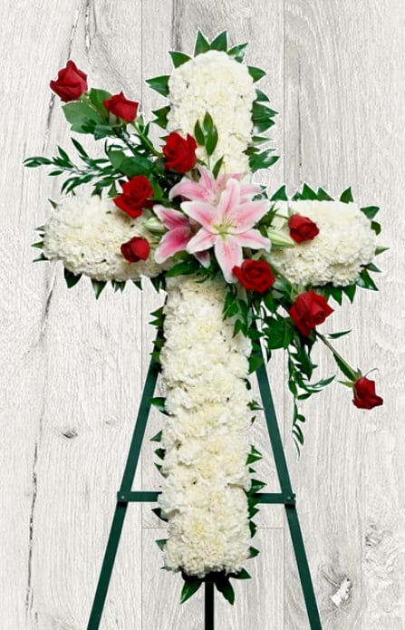 Commemorate fidelity with this standing spray cross of white blossoms adorned with
