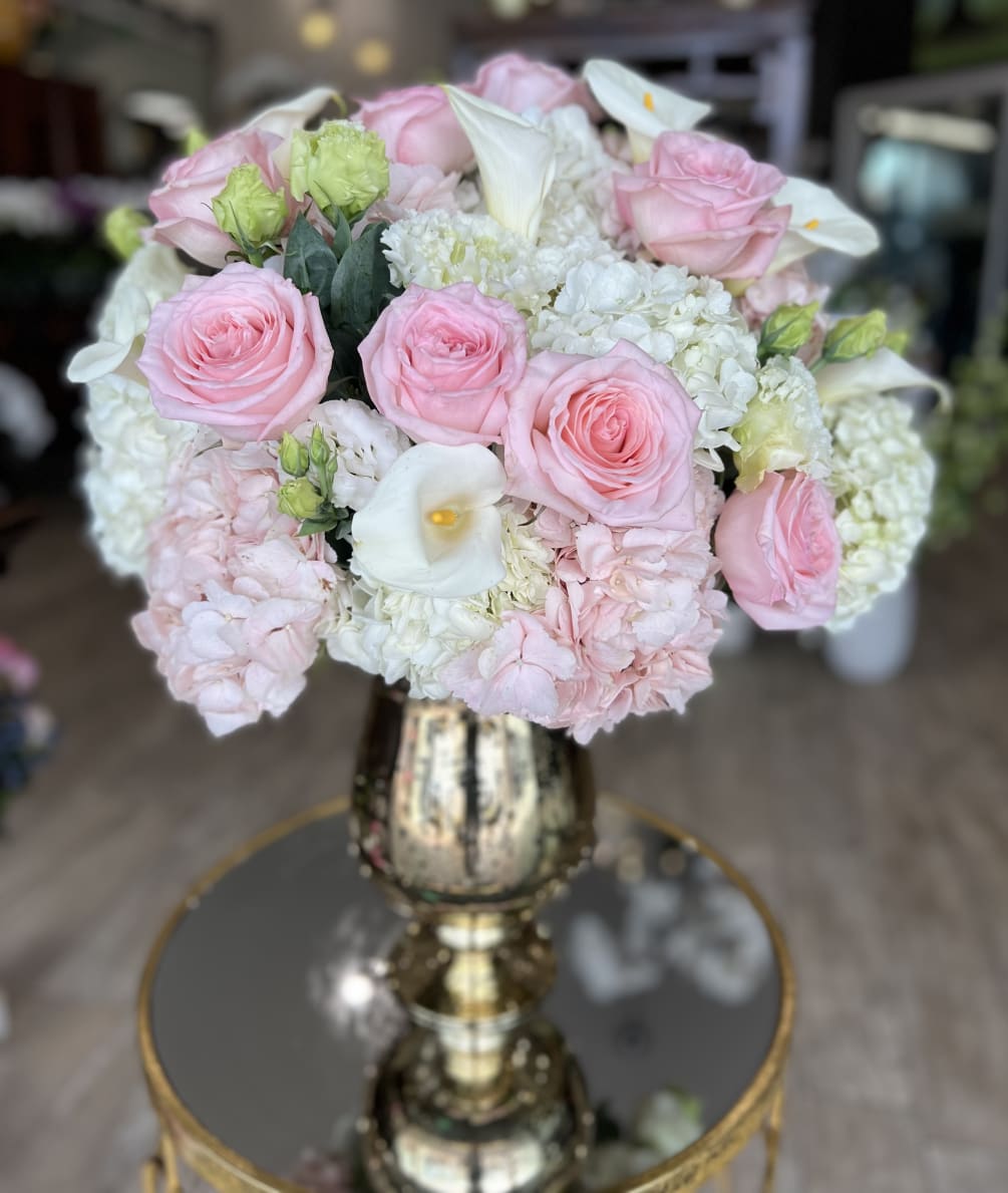 Gorgeous garden roses, hydrangea, lisianthus, and calla lilies in beautiful gold vase