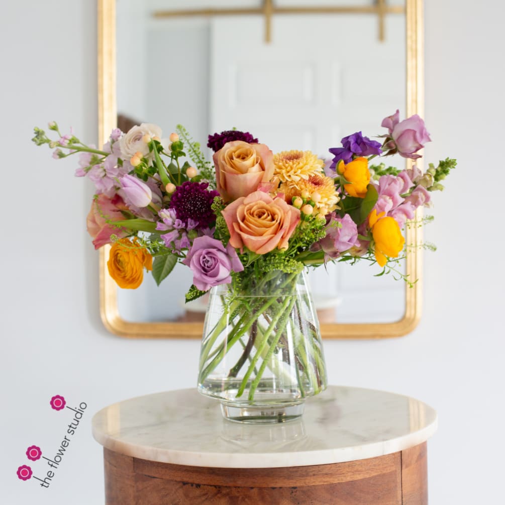 A beautiful seasonal floral arrangement in a beautiful clear vase. With a