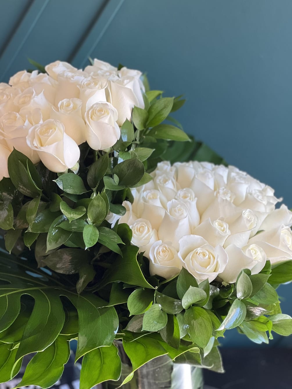 50 white roses design with greenery in a vase 