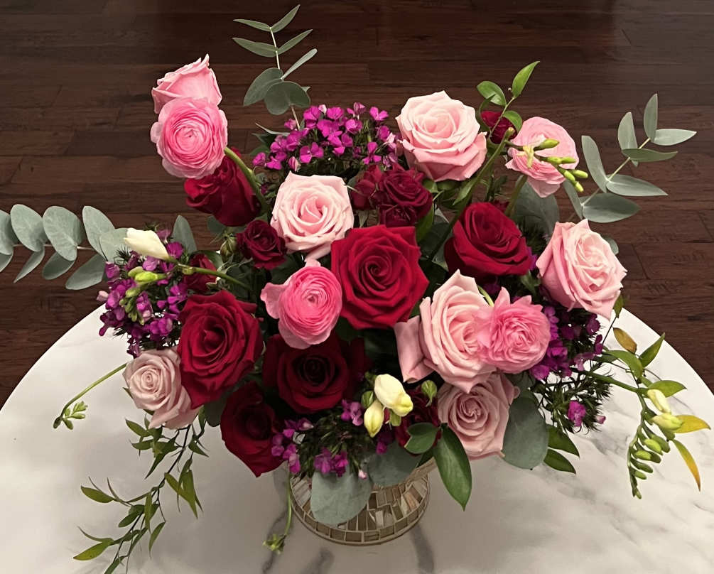 An extravagant red and pink arrangement with premium flowers.