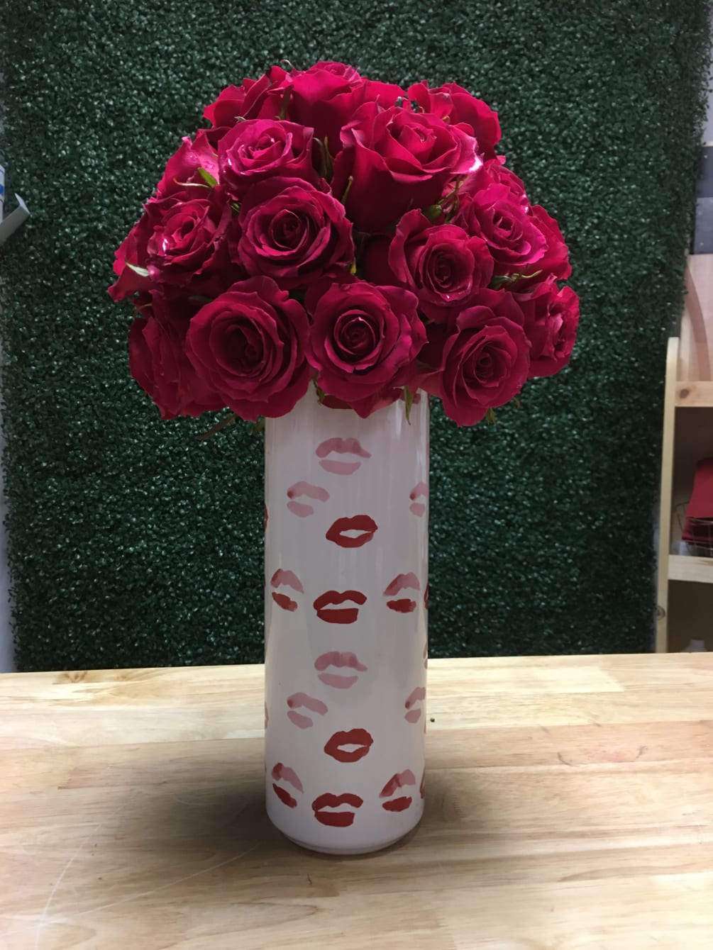 12 Roses atop a tall vases adorned with kisses.

SUBSITUTION POLICY
In many instances