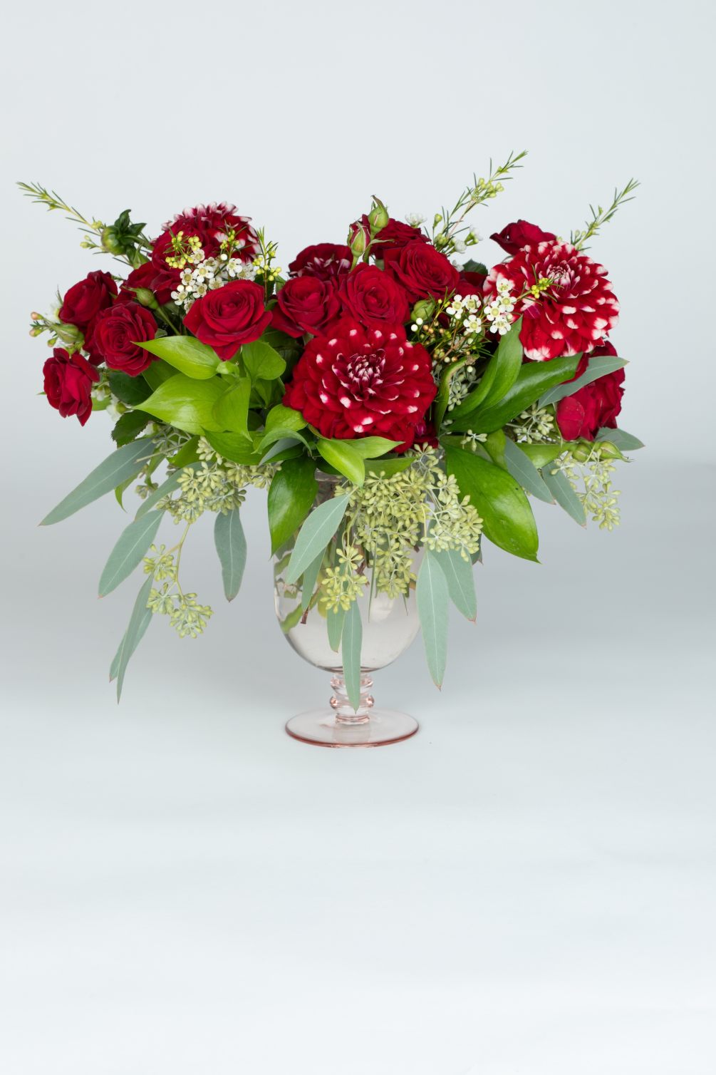 Red spray roses with dahlias and seeded eucalyptus and wax flower