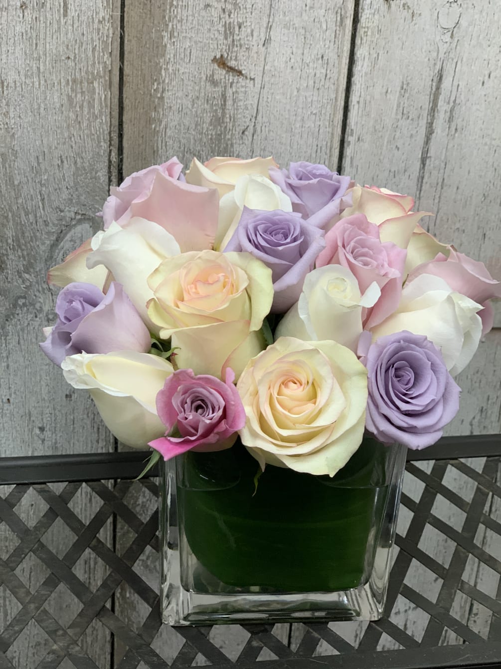 Mixture of soft pink. lavender, white cream roses. Contains at least 25