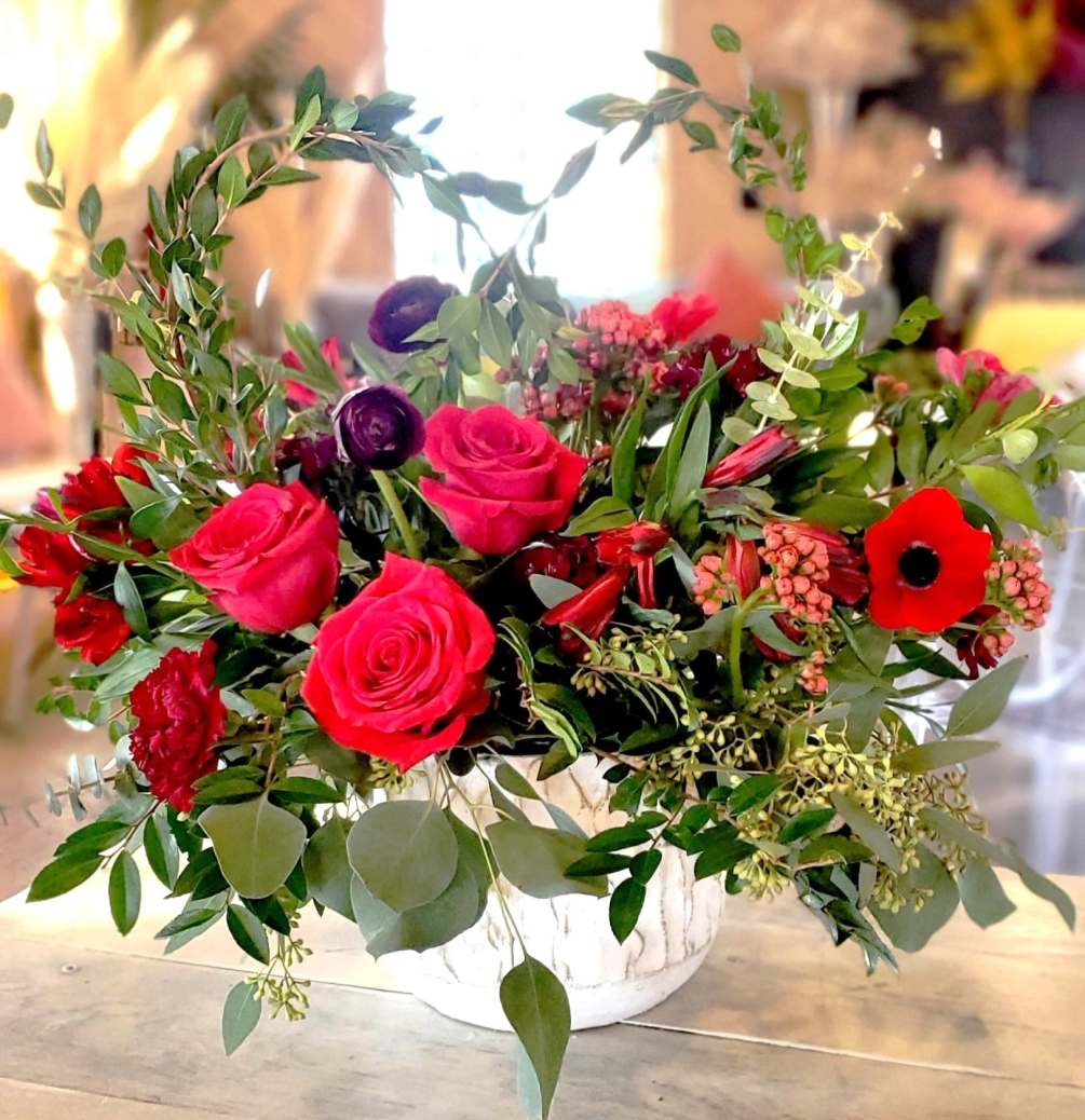 Red roses and stunning spring  flowers designed in reds and burgundy