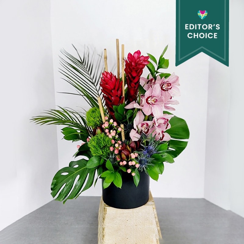This stunning arrangement is  filled with bold, beautiful flowers and foliage