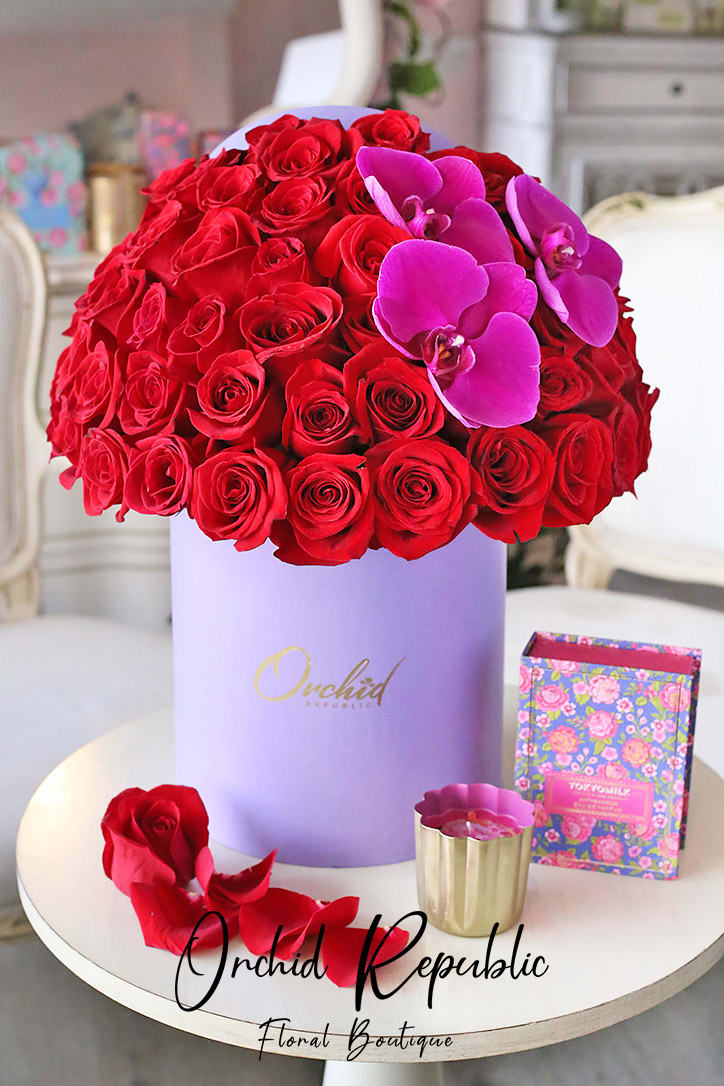 A swoon-worthy hatbox flower arrangement featuring a stunning display of passionate red
