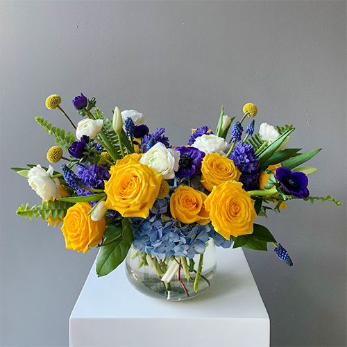 This sweet collection of flowers mixes fragrant spring blooms in cool blue