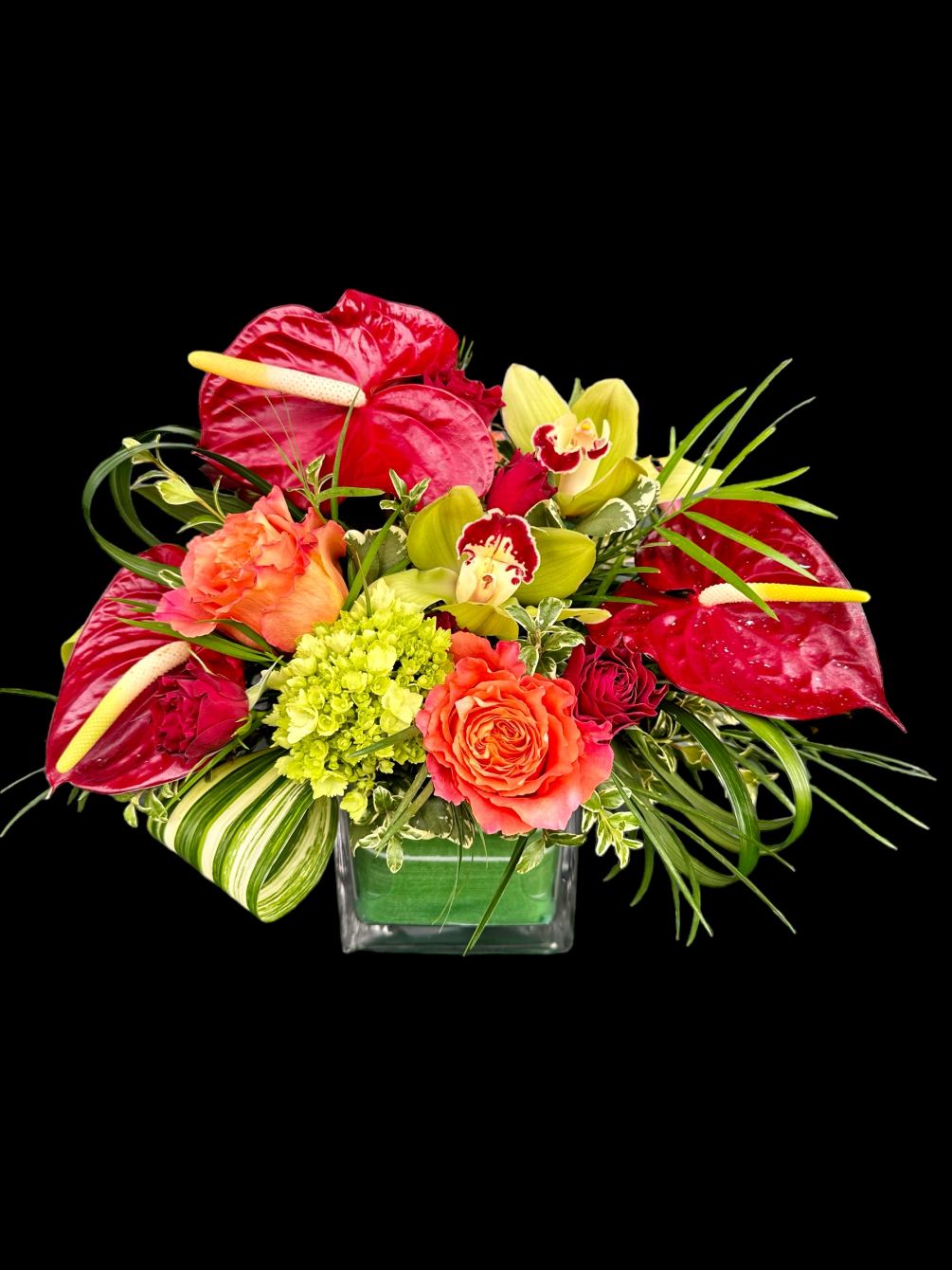 Beautiful red anthurium mixed with a passion of multi colored orchids, roses