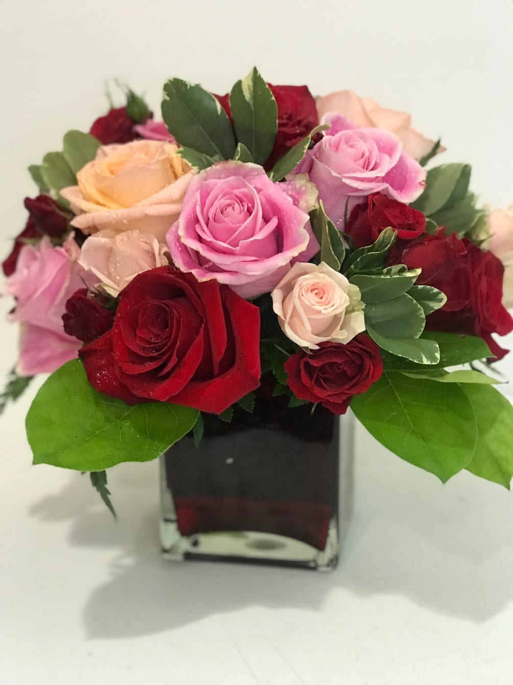 Surprise her with roses in four gorgeous shades of love artistically arranged