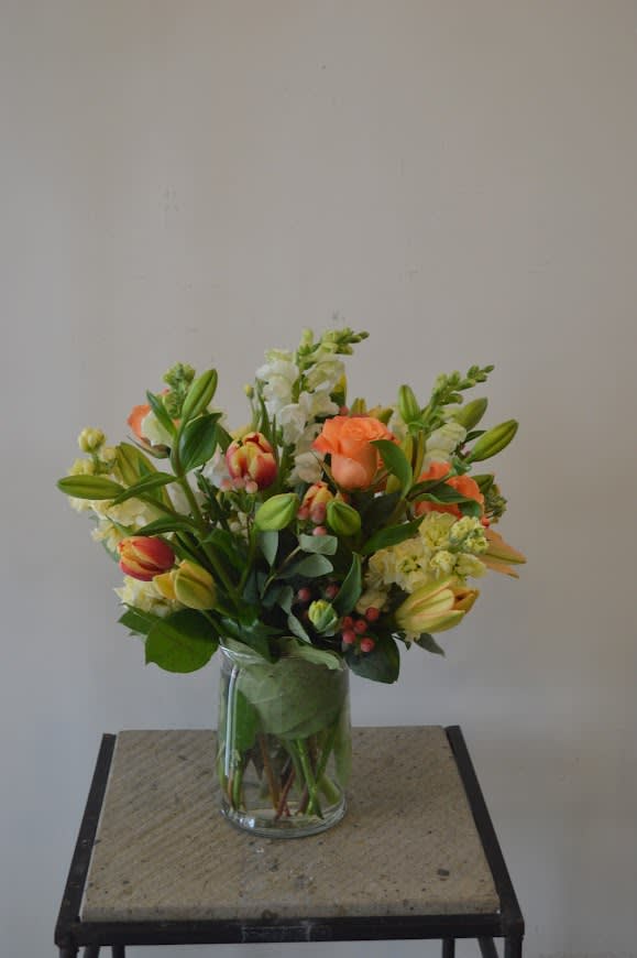 Orange Roses, yellow stock, white snapdragons, orange and yellow variegated tulips and
