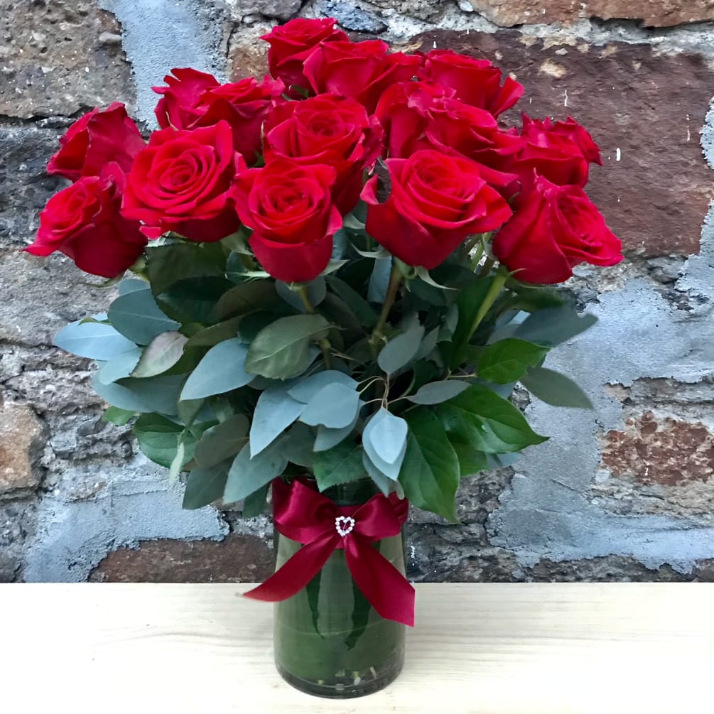 24 premium long stemmed red roses set hearts aflame set amongst blue
