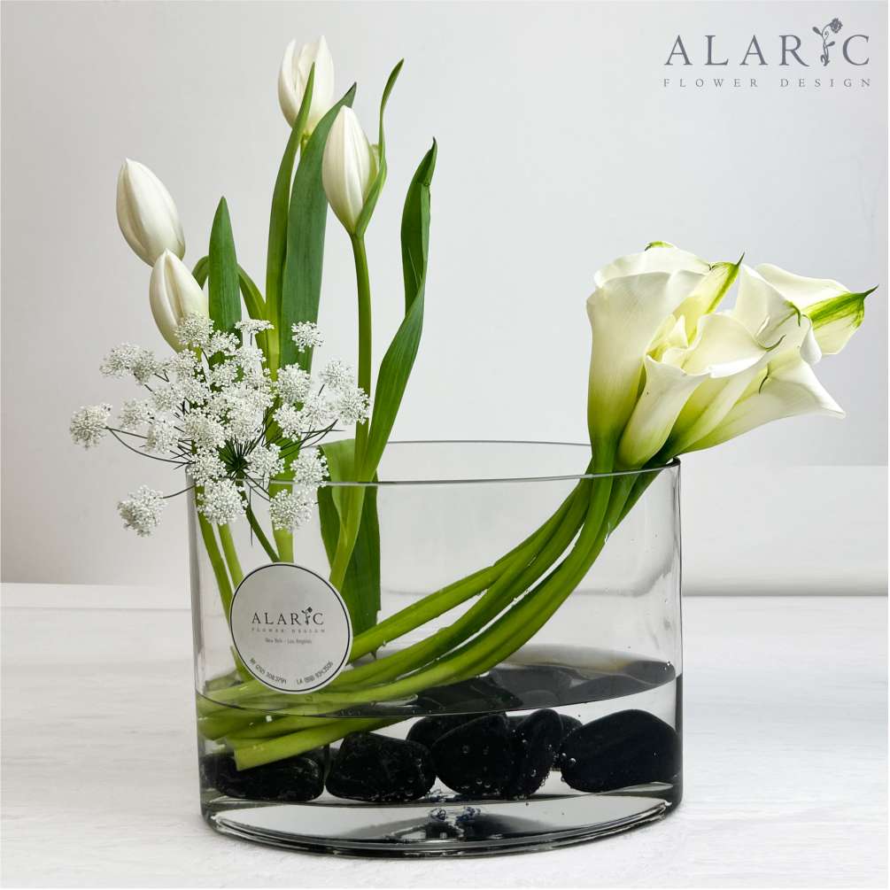 Elegance is a glass container with calla lilies and tulips! This gorgeous