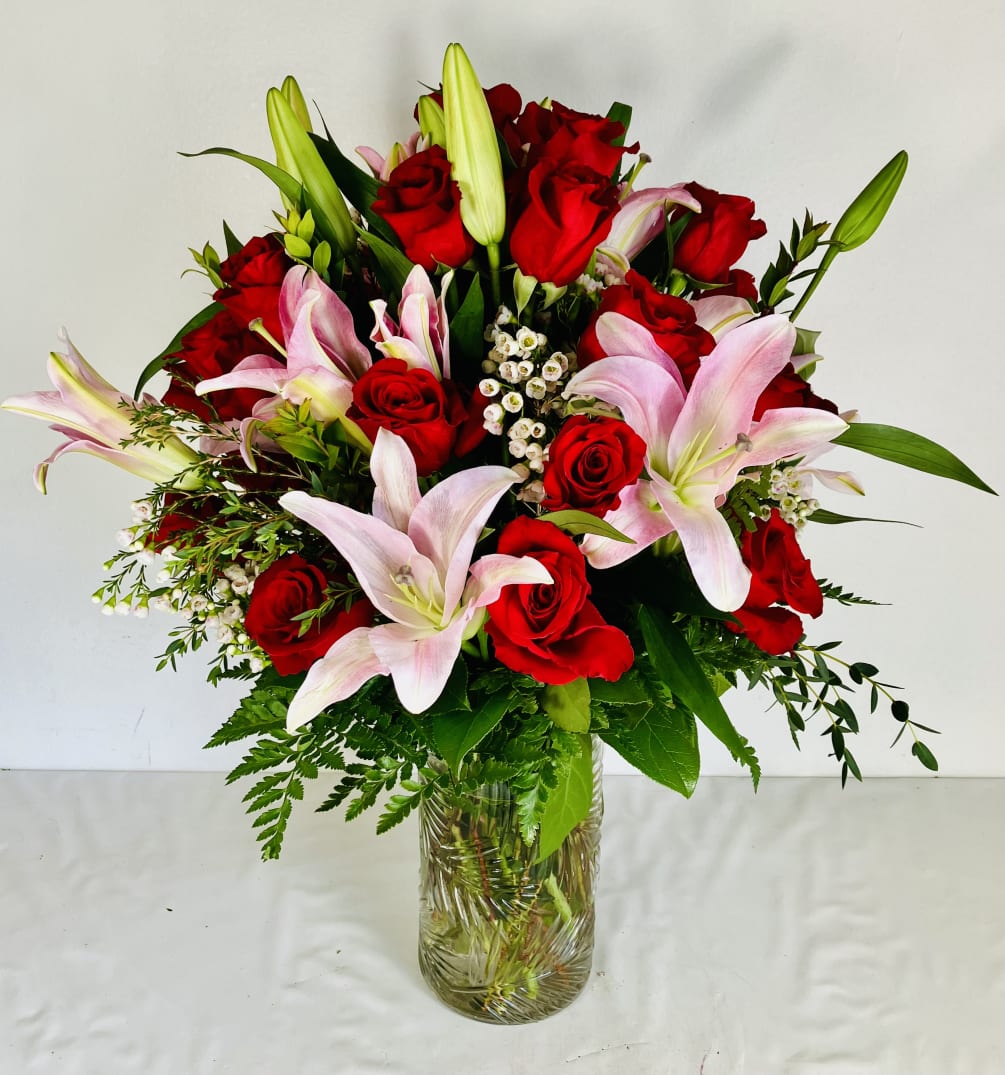 Two dozen red roses and pink lilies brought together to create this